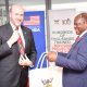 Prof. Barnabas Nawangwe, Vice Chancellor of Makerere University, presents a gift bag to U.S. Ambassador William W. Popp during his visit to the University