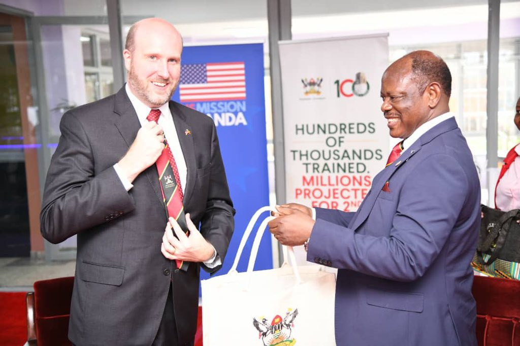 Prof. Barnabas Nawangwe, Vice Chancellor of Makerere University, presents a gift bag to U.S. Ambassador William W. Popp during his visit to the University