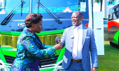 The Vice Chancellor, Prof. Barnabas Nawangwe (Right) handing over keys of branded buses to Prof. Gorettie N. Nabanoga the Principal College of Agricultural and Environmental Science