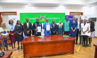 Vice Chancellor, Prof. Barnabas Nawangwe with Managing Director DFCU, Mr. Charles Mudiwaa holding the MoU in witness of other officials