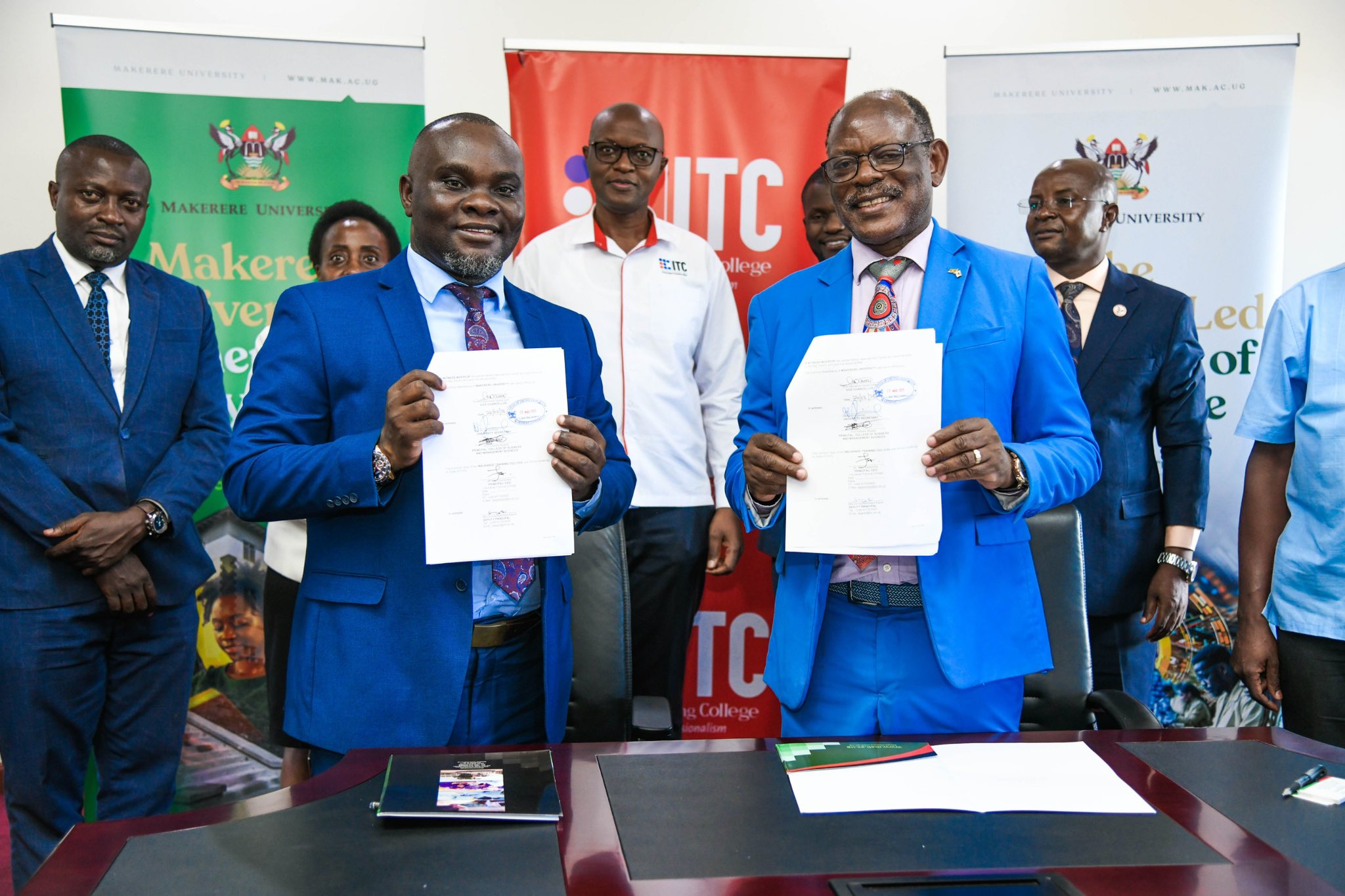 Prof. Barnabas Nawangwe, the Vice Chancellor and Mr. Saul Seremba, the Executive Director of the Insurance Training College show off the signed MoU