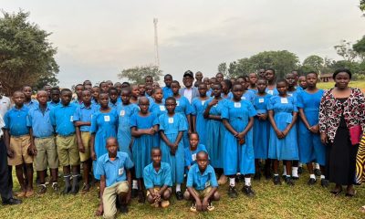 Vice Chancellor, Prof. Barnabas Nawangwe poses with Primary Seven candidates and their teachers at Busia Integrated Primary School.