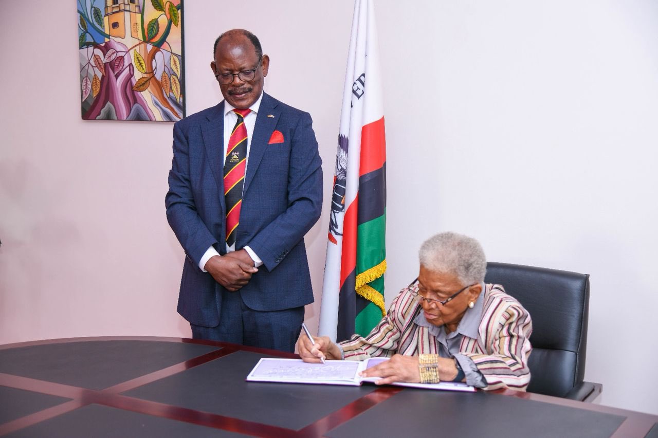 Her Excellency Ellen Johnson Sirleaf, former president of Liberia and first African woman President flanked by the Vice Chancellor, Prof. Barnabas Nawangwe signing in the visitor's book