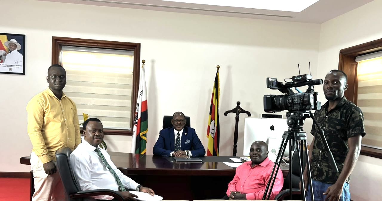 The Vice Chancellor, Prof. Barnabas Nawangwe (center) chats with the Makerere University Institute for Online Distance and e-Learning (IODeL) Multimedia team