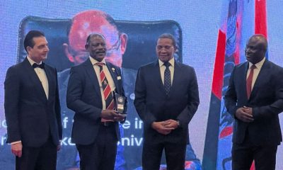 The Vice Chancellor, Prof. Barnabas Nawangwe (2ND L) receiving his award along side other officials.