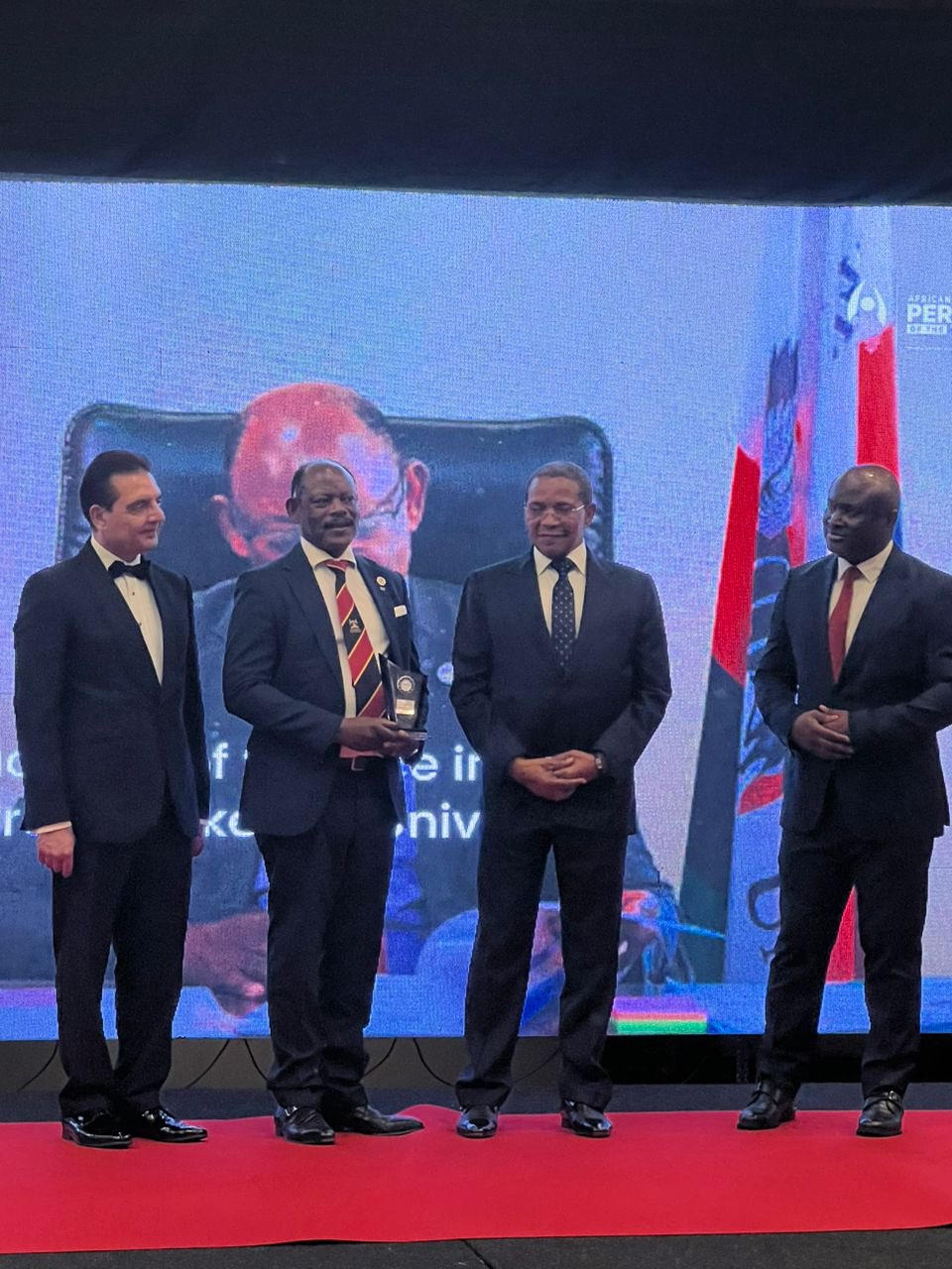 The Vice Chancellor, Prof. Barnabas Nawangwe (2ND L) receiving his award along side other officials.