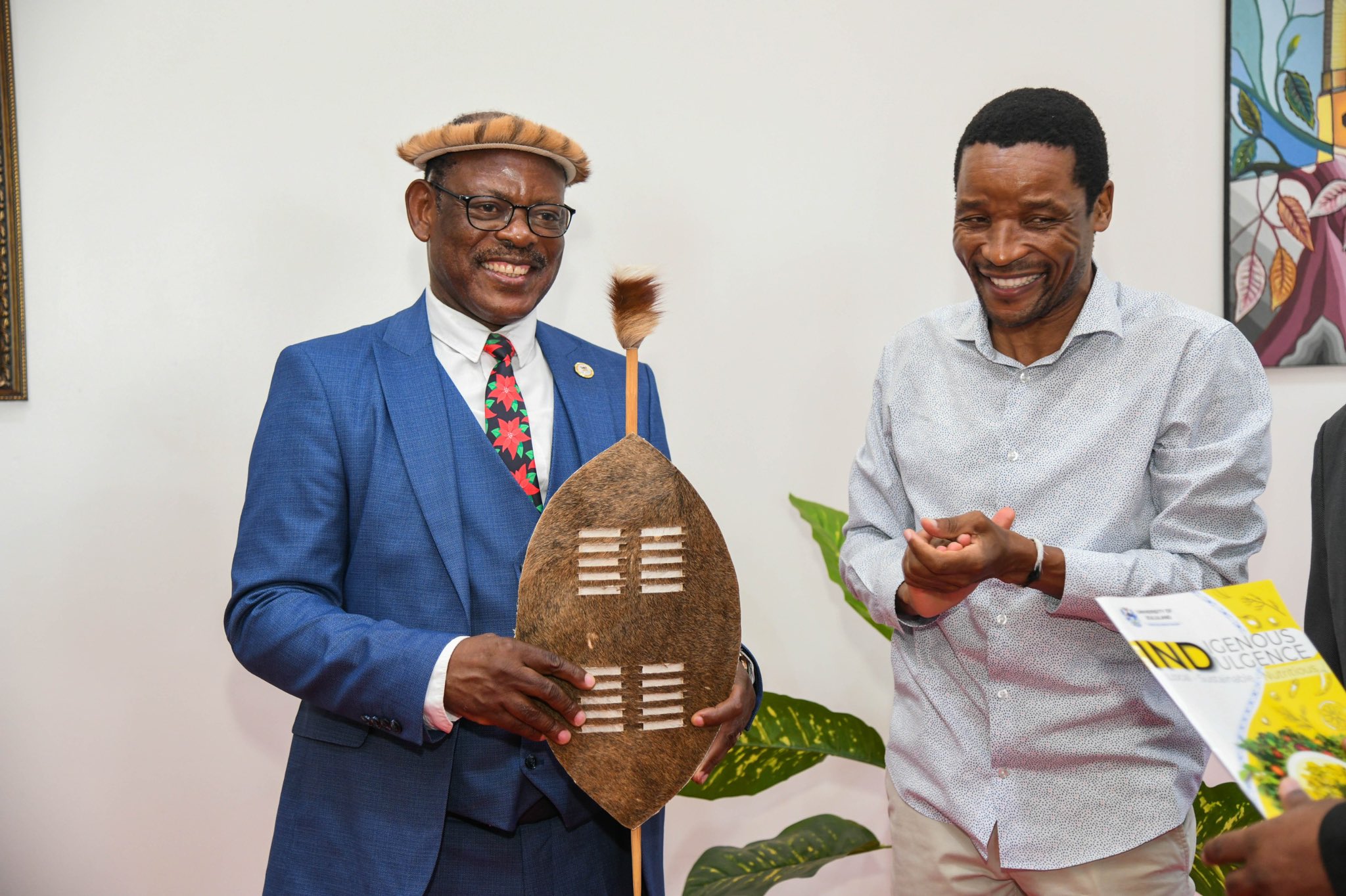 The Vice Chancellor, Prof. Barnabas Nawangwe (L) receiving the spears and shield from a delegation during a meeting at Makerere University.