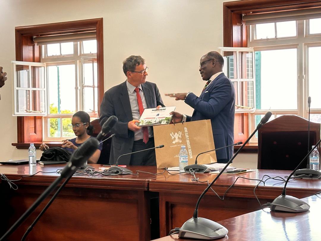 Prof. Barnabas Nawangwe (Right) handing over a gift to Mr. Laurent Bochereau meeting with Makerere University Top Management.