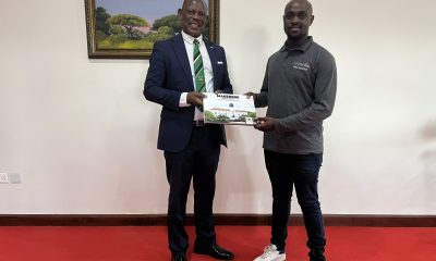 The Vice Chancellor, Prof. Barnabas Nawangwe (L) handing a gift to the Guild President from the University of South Africa (R) during their benchmarking at Makerere University.