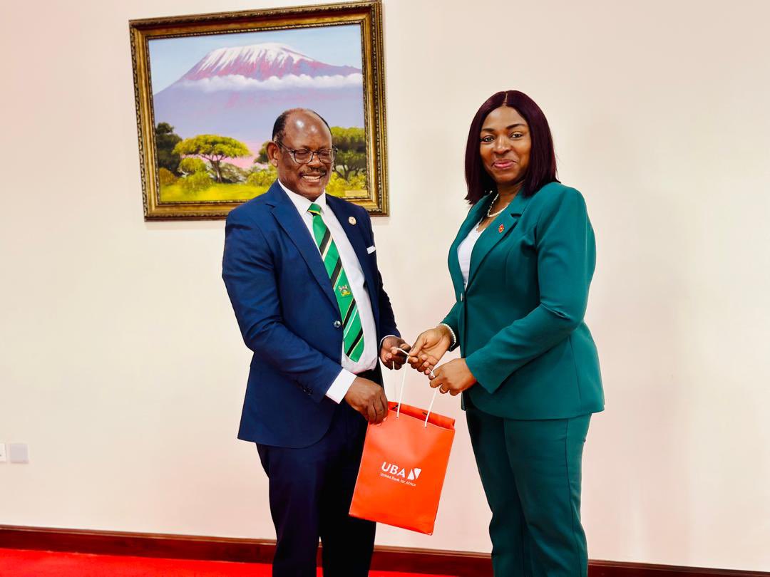 The Vice Chancellor, Prof. Barnabas Nawangwe (L) receiving a souvenir from the Executive Director of UBA, Ms. Chinwe Chinedu-Chika (R) during a meeting at Makerere University.