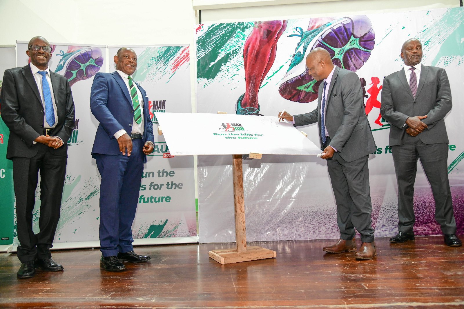 The Vice Chancellor, Prof. Barnabas Nawangwe (2ND L) with the Minister of State for sports, Hon. Peter Ogwang (2ND R) along side other officials.