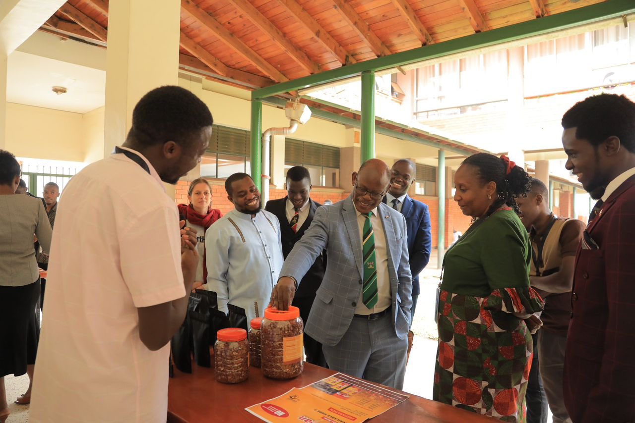 The Vice Chancellor, Prof. Barnabas Nawangwe (C) inspecting some of the sample work done at the Centre while at the lunch.