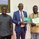 Prof. Barnabas Nawangwe (Center) with H.E. Vincent Lubega Nsamba (Left) and Ochom Felix (Right) pose as they show off the award