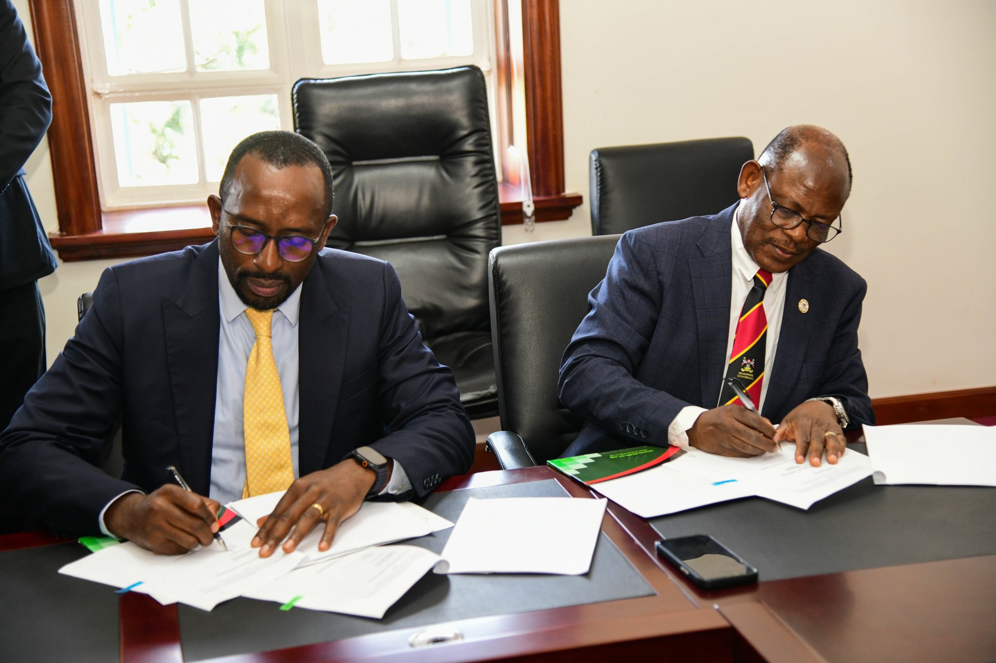 The Vice Chancellor, Prof. Barnabas Nawangwe (R) and the Chairman of NCS, Mr. Ambrose Tashobya (L) during the signing ceremony at Makerere University.