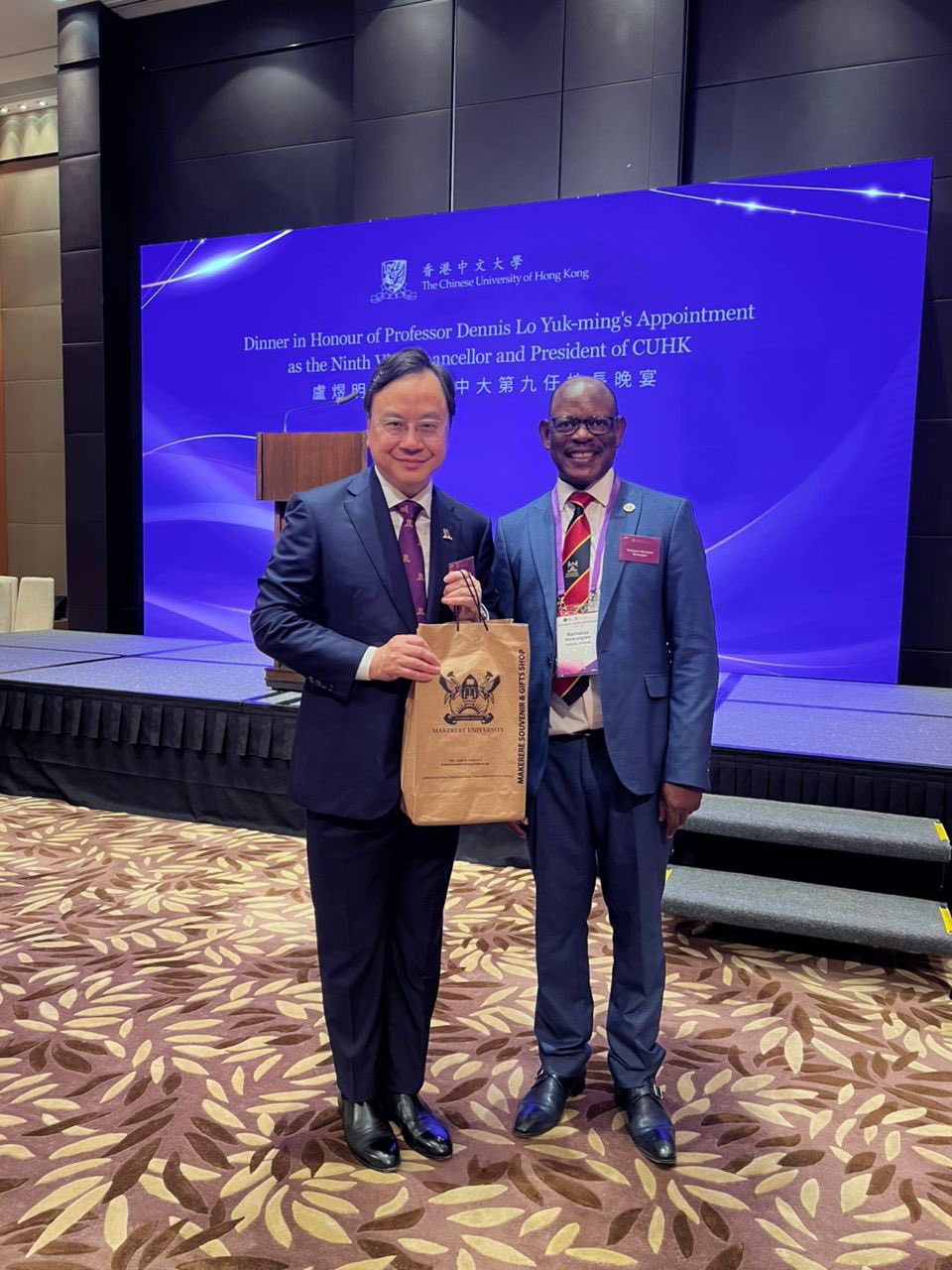 The Vice Chancellor, Prof. Barnabas Nawangwe (R) and Prof. Dennis Lo Yuk-ming (L) with his congratulatory gift.