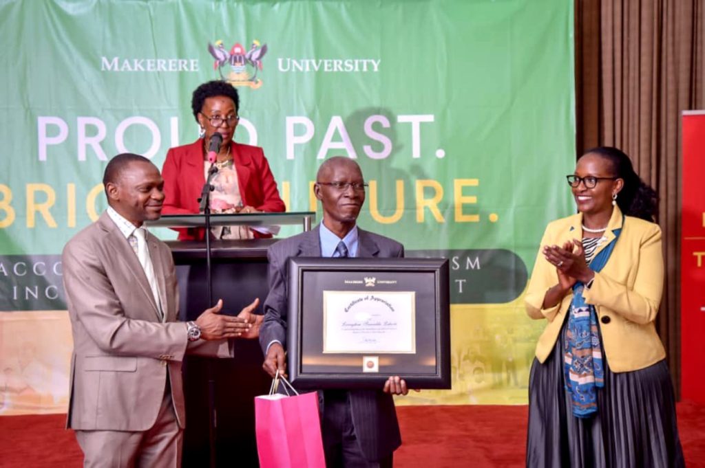 Professor Livingstone Luboobi shows off his certificate of appreciation during Makerere University's celebration of her Legacy of Leadership on 17th March 2023. Kampala Serena Hotel, Uganda, East Africa.