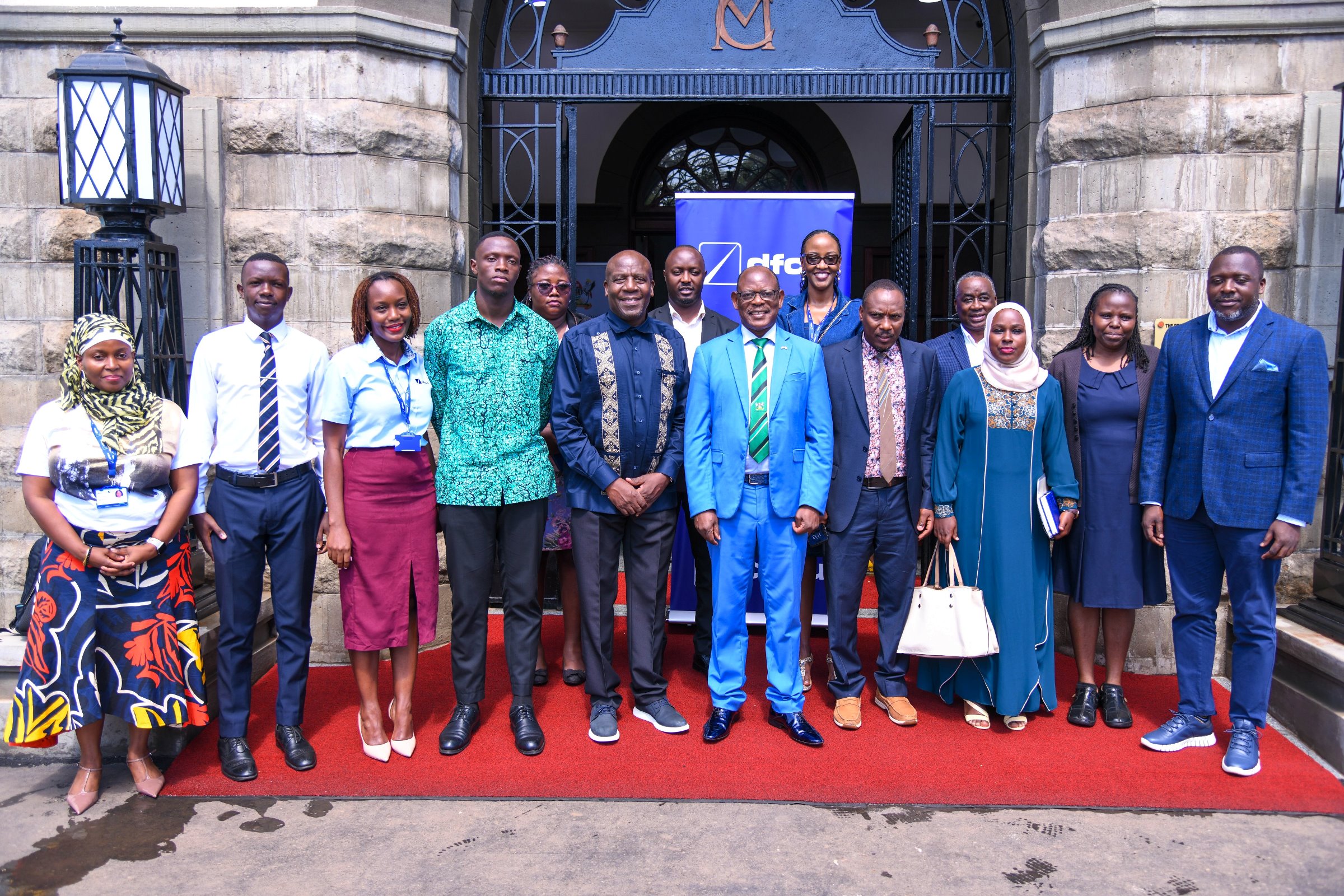 Officials from Makerere University and DFCU Bank pose for a group photo at the Main Building Entrance after the MoU signing ceremony on 4th July 2025. Makerere University and DFCU Bank Limited sign a three-year Memorandum of Understanding (MoU) designed to enhance academic excellence, advance research and innovation capabilities, and provide crucial student support services through key activities; Annual Tumusiime Muteile Lecture, MakRun and Student activities, 4th July 2025, Council Room, Main Building, Makerere University, Kampala Uganda, East Africa.