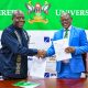The Vice Chancellor-Prof. Barnabas Nawangwe (R) and MD DFCU Bank-Mr. Charles Mudiwa (L) shake hands after exchanging the signed MoU on 4th July 2025. Makerere University and DFCU Bank Limited sign a three-year Memorandum of Understanding (MoU) designed to enhance academic excellence, advance research and innovation capabilities, and provide crucial student support services through key activities; Annual Tumusiime Muteile Lecture, MakRun and Student activities, 4th July 2025, Council Room, Main Building, Makerere University, Kampala Uganda, East Africa.