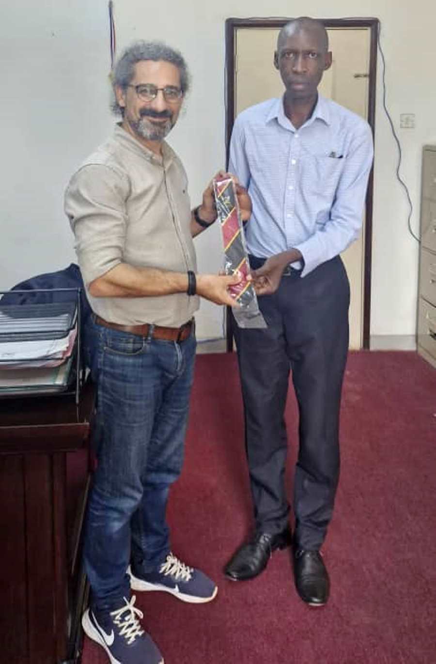 Prof. Anthony Muwagga Mugagga presents a Mak Necktie to Prof. İbrahim Hakan Karataş on 24th July 2025. Prof. İbrahim Hakan Karataş Visiting Scholar at Makerere University and Professor at İstanbul Medeniyet University, Turkey. Time at College of Education and External Studies and farewell on 24th July 2025, Kampala Uganda, East Africa.