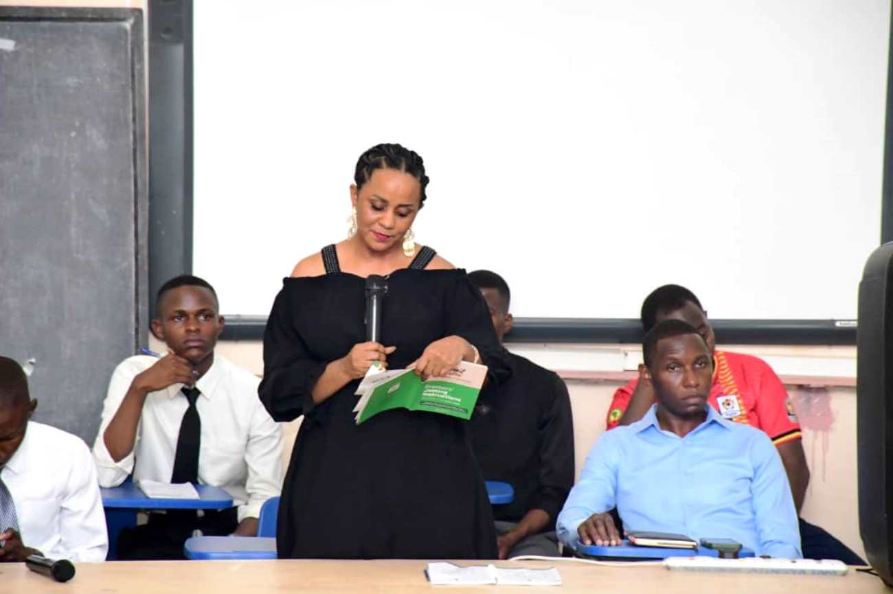 Ms Molly Nantongo, School Registrar presenting crucial information to students as Hon. Samuel Asingya (white shirt) and other student leaders keenly follow the proceedings. School of Education, College of Education and External Studies (CEES) freshers’ orientation, School of Education Conference Hall, 8th August 2025, Makerere University, Kampala Uganda, East Africa.