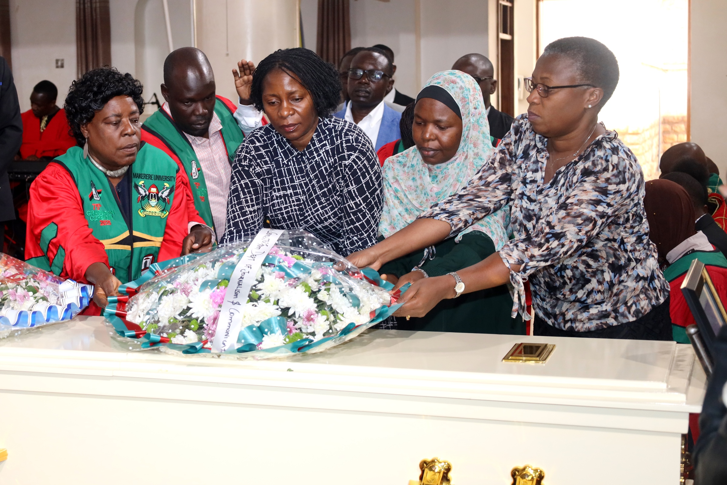 Left to Right: Prof. Gorretti Nassanga, Dr. John Baptist Imokola, Ms. Harriet Sebaana, Dr. Wilson Kaija, Dr. Aisha Nakiwala, Dr. Charlotte Ntulume and other colleagues lay a wreath on Dr. Brian Semujju's casket in St. Francis Chapel on 5th August 2025. Funeral service in honour of Dr. Brian Semujju-Senior Lecturer, Department of Journalism and Communication, School of Languages Literature and Communication, College of Humanities and Social Sciences (CHUSS), 5th August 2025, St. Francis Chapel, Makerere University, Kampala Uganda, East Africa.