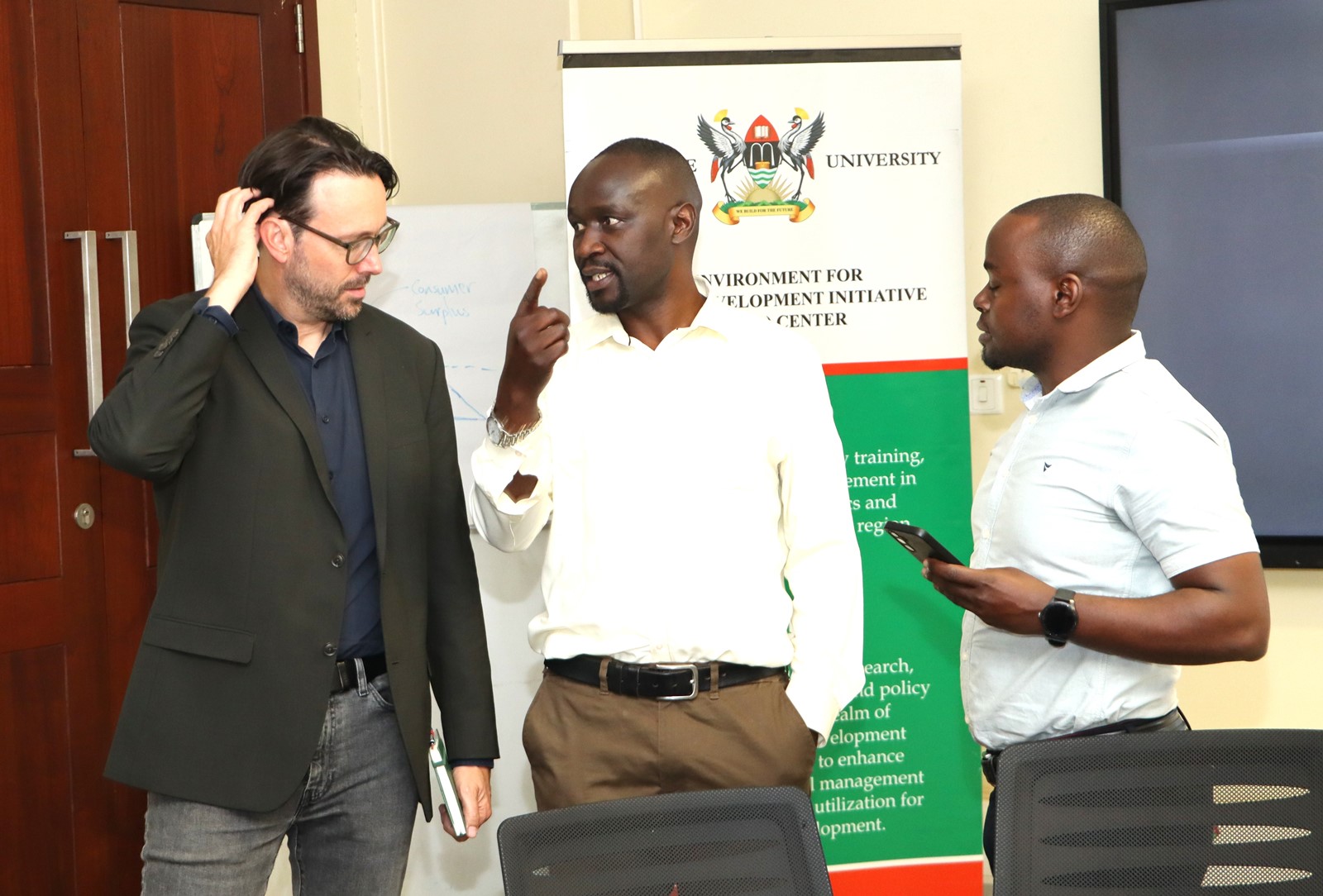 Prof. Purdon, Dr. Patrick Byakagaba and a student interact after the seminar. Prof. Mark Purdon seminar and launch of his new book "The Political Economy of Climate Finance Effectiveness in Developing Countries: Carbon Markets, Climate Funds, and the State" hosted by the Environment for Development (EfD) Makerere Centre, 27th August 2025, Yusuf Lule Central Teaching Facility, Makerere University, Kampala Uganda, East Africa.