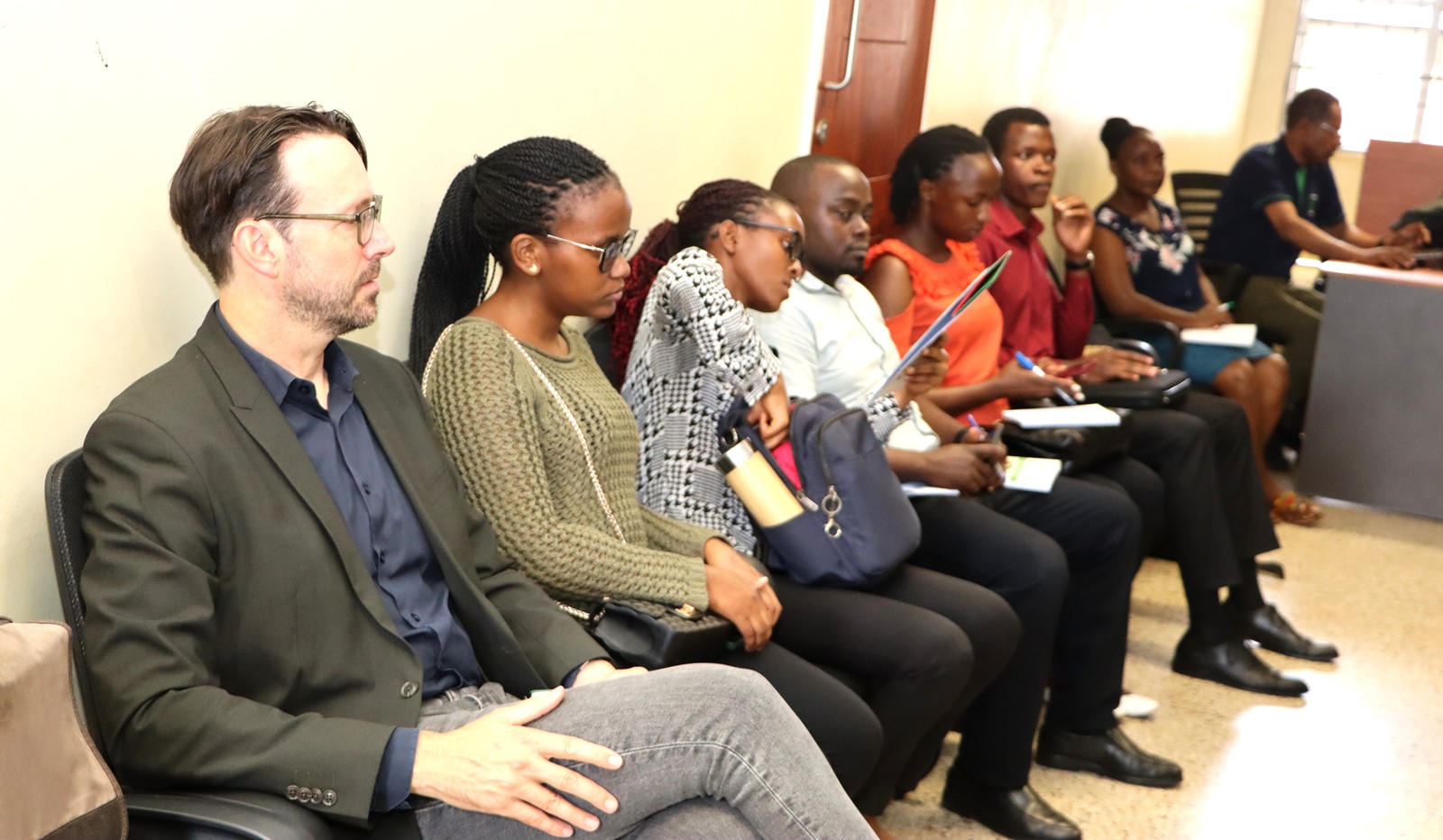 Prof. Purdon and a section of graduate students before presenting. Prof. Mark Purdon seminar and launch of his new book "The Political Economy of Climate Finance Effectiveness in Developing Countries: Carbon Markets, Climate Funds, and the State" hosted by the Environment for Development (EfD) Makerere Centre, 27th August 2025, Yusuf Lule Central Teaching Facility, Makerere University, Kampala Uganda, East Africa.