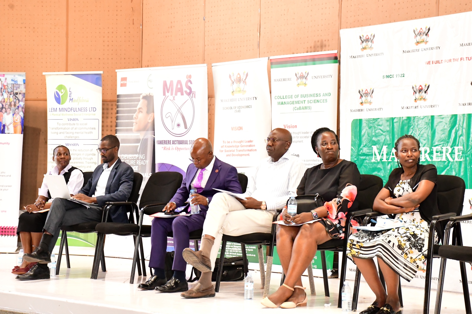 L-R, Mrs. Juliet Ssewankambo (AG.Colllege Registrar), Mr. Gilbert Nizeyimaana (DICTS), Prof. Edward Bbaale (Principal), Mr. Peter Mubiru (College Bursar), Ms Rose Nalwanga (Senior Counselor), and Ms Claire Nakaseeta-representing the College Librarian. College of Business and Management Sciences (CoBAMS) Orientation for First Year Students 5th-8th August 2025, Day One, 5th August 2025, Yusuf Lule Central Teaching Facility Auditorium, Makerere University, Kampala Uganda, East Africa.
