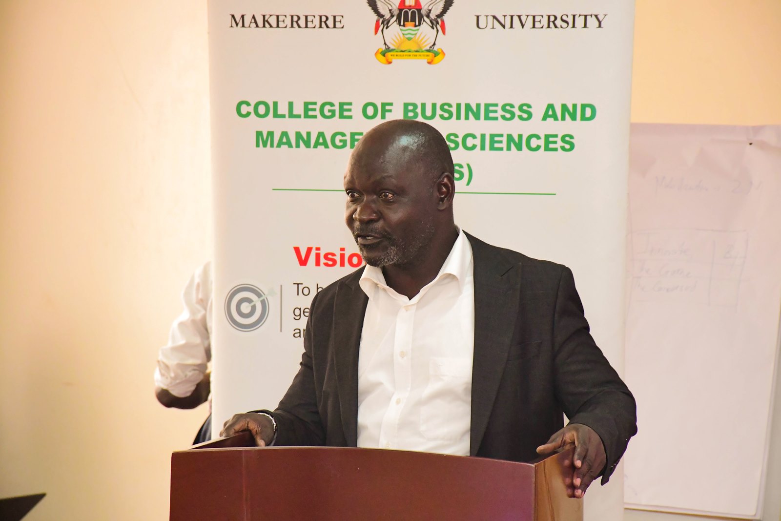 Associate Professor Faisal Buyinza. Presentation: “Africa’s Growth Trends and Prospects in Light of Evolving Global Challenges” by Dr. Paul Mpuga, a visiting Scholar and Division Manager for Microeconomic Policy, Debt Sustainability, and Forecasting in the Economic Governance and Knowledge Management Vice-Presidency of the African Development Bank Group, 19th August 2025, Conference Room, Level 2, Block B, College of Business and Management Sciences (CoBAMS), Makerere University, Kampala Uganda, East Africa.