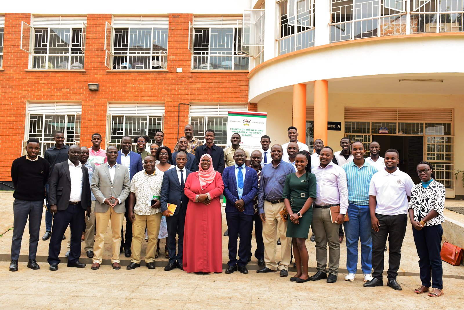 Dr. Paul Mpuga (3rd Left) poses for a group photo with participants after his presentation on 19th August 2025. Presentation: “Africa’s Growth Trends and Prospects in Light of Evolving Global Challenges” by Dr. Paul Mpuga, a visiting Scholar and Division Manager for Microeconomic Policy, Debt Sustainability, and Forecasting in the Economic Governance and Knowledge Management Vice-Presidency of the African Development Bank Group, 19th August 2025, Conference Room, Level 2, Block B, College of Business and Management Sciences (CoBAMS), Makerere University, Kampala Uganda, East Africa.