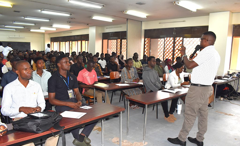 Mr. David Kisitu, ICT Officer at CoNAS moderated the session. College of Natural Sciences (CoNAS) orientation ceremony to acquaint new students with College structures, academic programmes, services, and, its contribution to the University’s core functions, 6th August 2025, JICA Building, Makerere University, Kampala Uganda, East Africa.