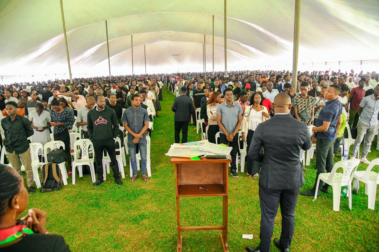 The day's emcee, Mr. Gerald Ochwo (Back to camera) addresses the full house at the event. Makerere University officially kicks off 2025/2026 academic year with a Freshers’ Orientation at the Freedom Square on Monday 4th August 2025, Kampala Uganda, East Africa.