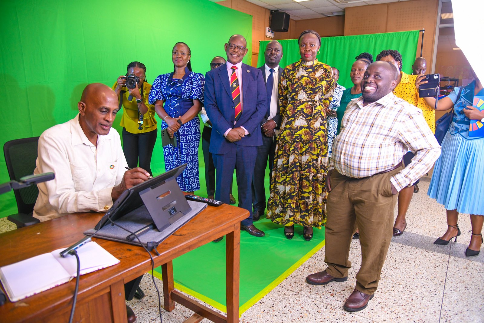 Dr. Godfrey Mayende observes as Mr. Ian King tests the Multimedia Studio's provisions that support teaching of subjects that necessitate writing of formulae and other hand-drawn illustrations. Makerere University, in collaboration with UNDP Uganda launch of Daycare and Breastfeeding Centre at the Institute of Gender and Development Studies (IGDS) and state-of-the-art Multimedia Studio at the Frank Kalimuzo Central Teaching Facility, 7th August 2025, Kampala Uganda, East Africa.