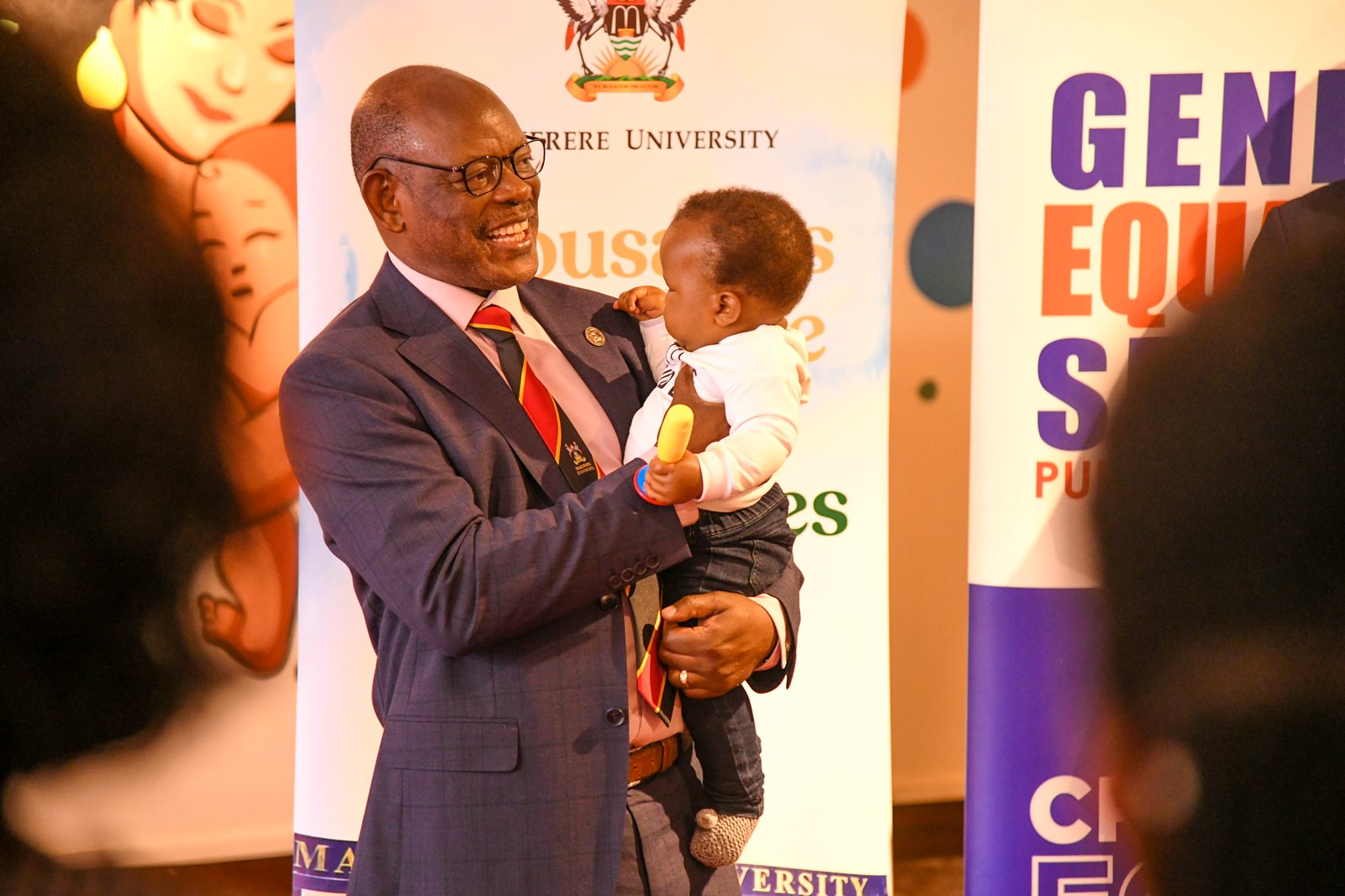 Prof. Barnabas Nawangwe holds a baby as he makes his remarks at the Daycare facility. Makerere University, in collaboration with UNDP Uganda launch of Daycare and Breastfeeding Centre at the Institute of Gender and Development Studies (IGDS) and state-of-the-art Multimedia Studio at the Frank Kalimuzo Central Teaching Facility, 7th August 2025, Kampala Uganda, East Africa.
