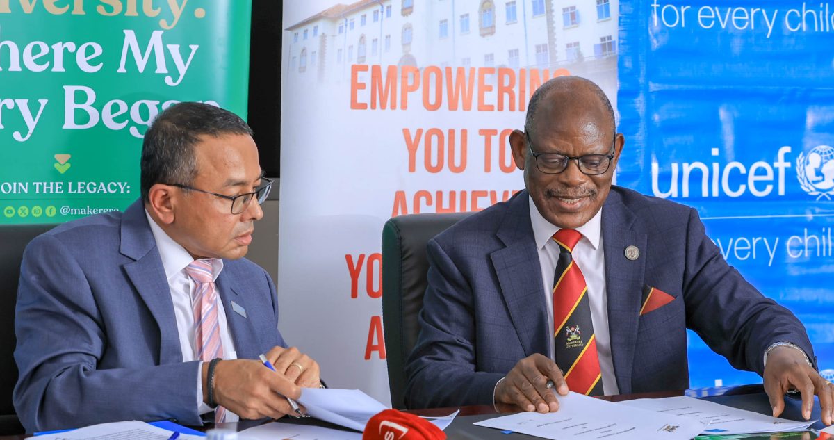 Makerere University Vice Chancellor, Prof. Barnabas Nawangwe, exchanges documents with UNICEF Uganda Representative, Dr. Robin Nandy, during the signing of an MoU on August 14, 2025. The two-year renewable partnership seeks to advance child rights and well-being, a critical public health priority in Uganda.