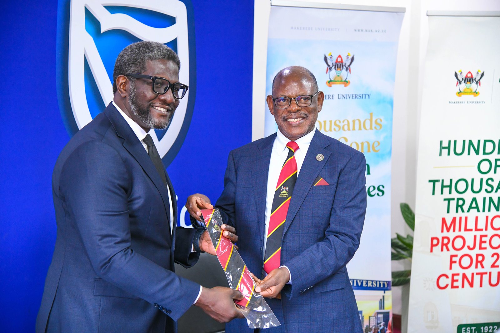 Prof. Barnabas Nawangwe presents a Mak Necktie to Mr. Samuel Mwogeza. Makerere University hosts delegation from Stanbic Bank to strengthen their longstanding relationship and explore future collaborations, 26th August 2025, Kampala Uganda, East Africa.