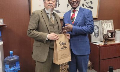 The Vice Chancellor, Prof. Barnabas Nawangwe (R) handing a gift to an official during his meeting in Japan.