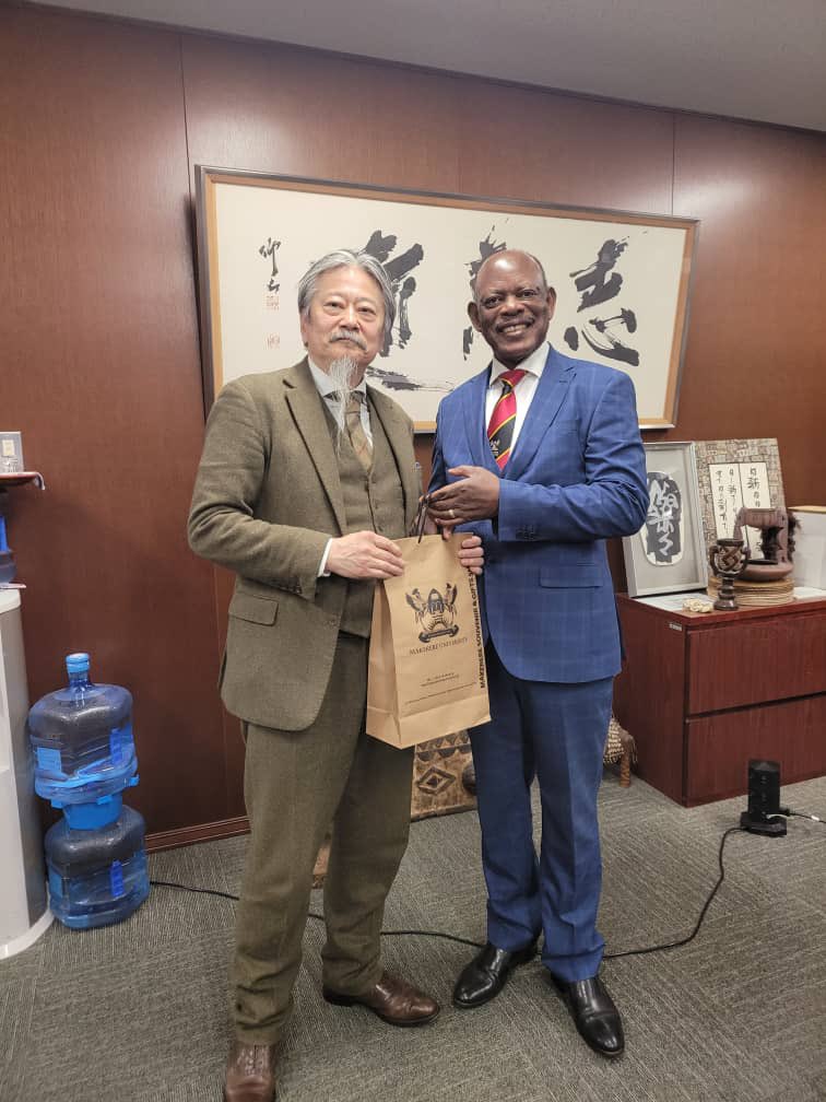 The Vice Chancellor, Prof. Barnabas Nawangwe (R) handing a gift to an official during his meeting in Japan.