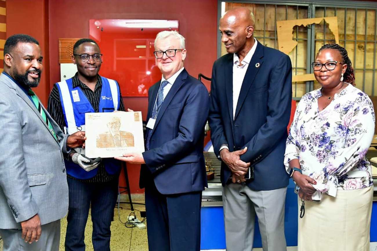Prof. Robert Wamala (Left) hands over the souvenir produced in the Mak UniPod to Mr. Michel Dewez (Centre) as Mr. Ian King (2nd Right), Dr. Margaret Nagwovuma (Right) and an official (2nd Left) witness on 1st September 2025. Delegation from the Belgian Embassy in Uganda, accompanied by representatives from ENABEL and the United Nations Development Programme (UNDP) visit to the Makerere University Innovation Pod (Mak UniPod), 1st September 2025, Kampala, East Africa.