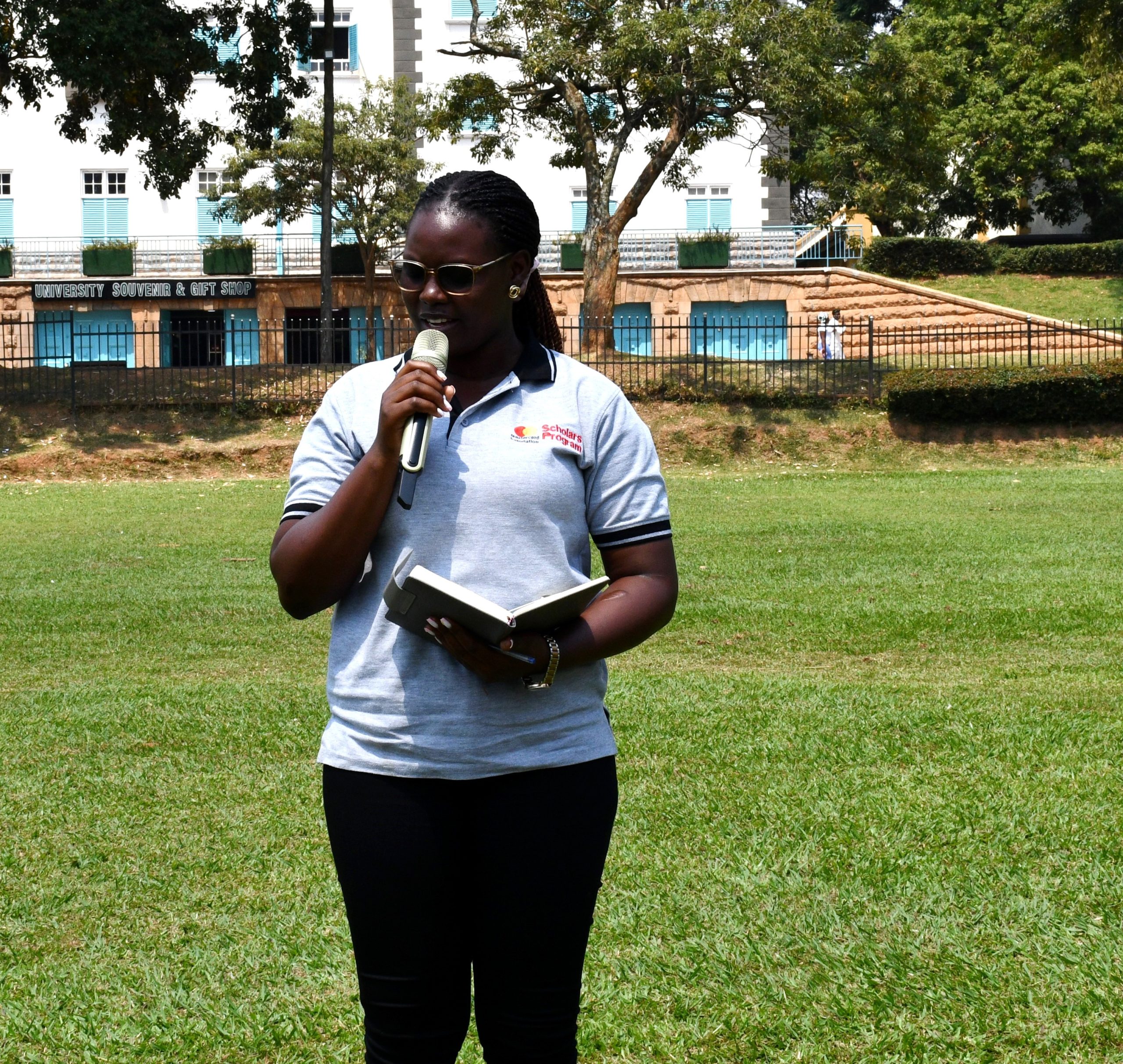 Ms. Malvin Akwara, a Scholar-alumna addressing fellow Scholars and alumni at the event. Mastercard Foundation Scholars Community Open Day, September 6, 2025, Freedom Square, Makerere University, Kampala Uganda, East Africa.