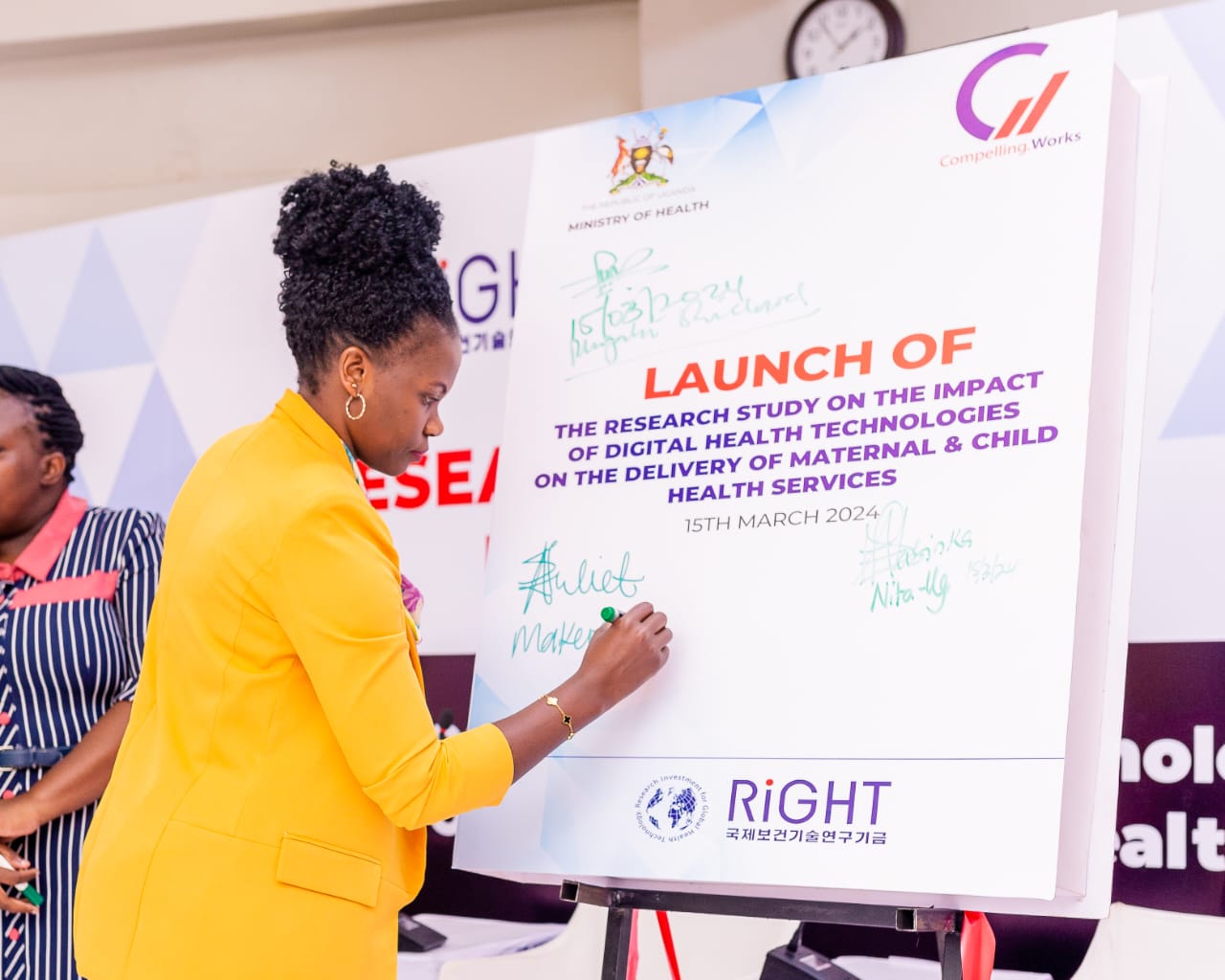 Dr. Juliet Aweko signing on the board at the launch of the Research Study on the Impact of Digital Health Technologies on Maternal and Child Health Services. March 15, 2024. MakSPH, Kampala Uganda, East Africa