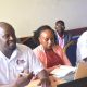 Dr. Abu Mayanja (L), the Chief Operations Officer, and other SAF staff at the meeting