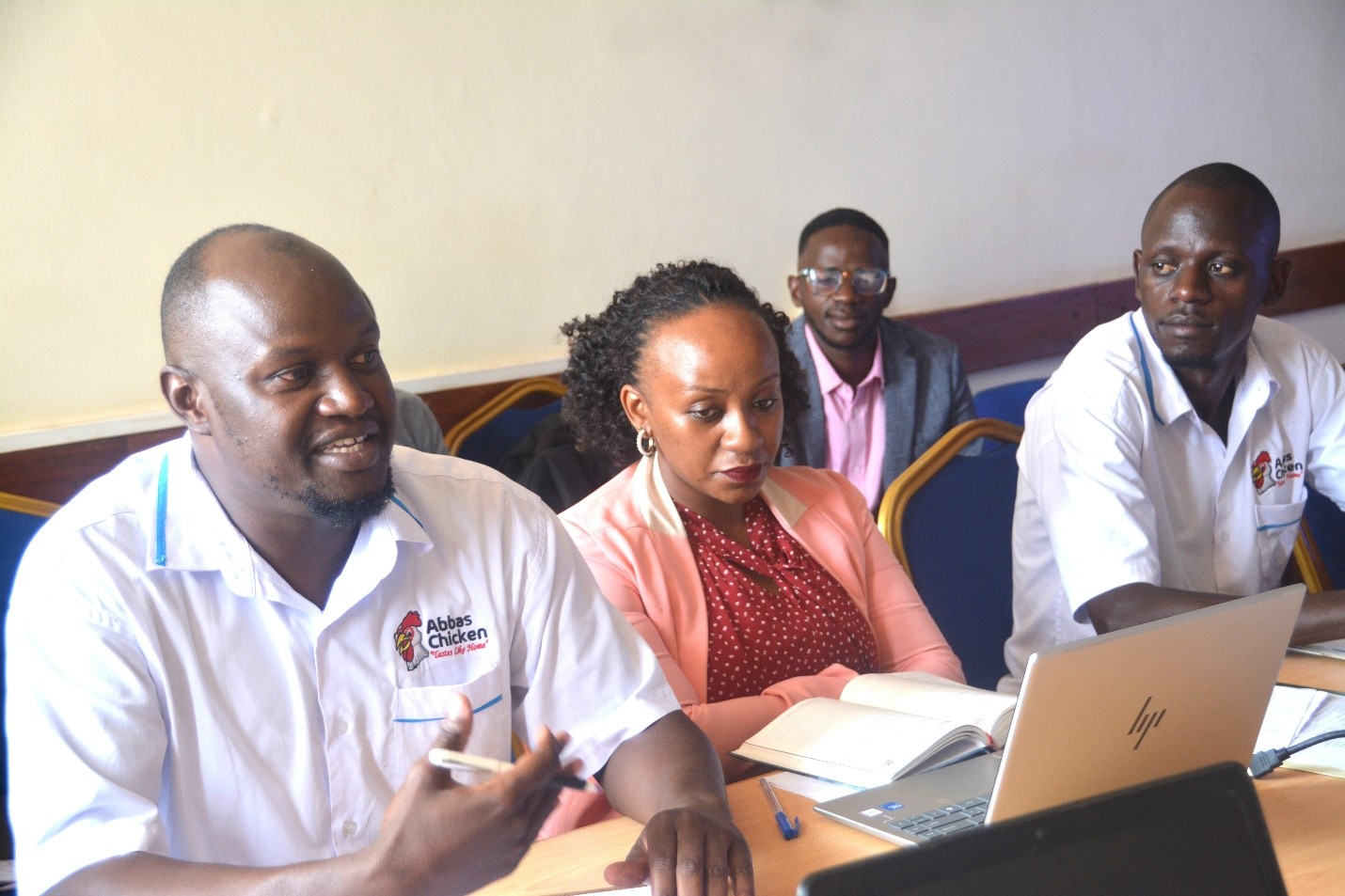 Dr. Abu Mayanja (L), the Chief Operations Officer, and other SAF staff at the meeting