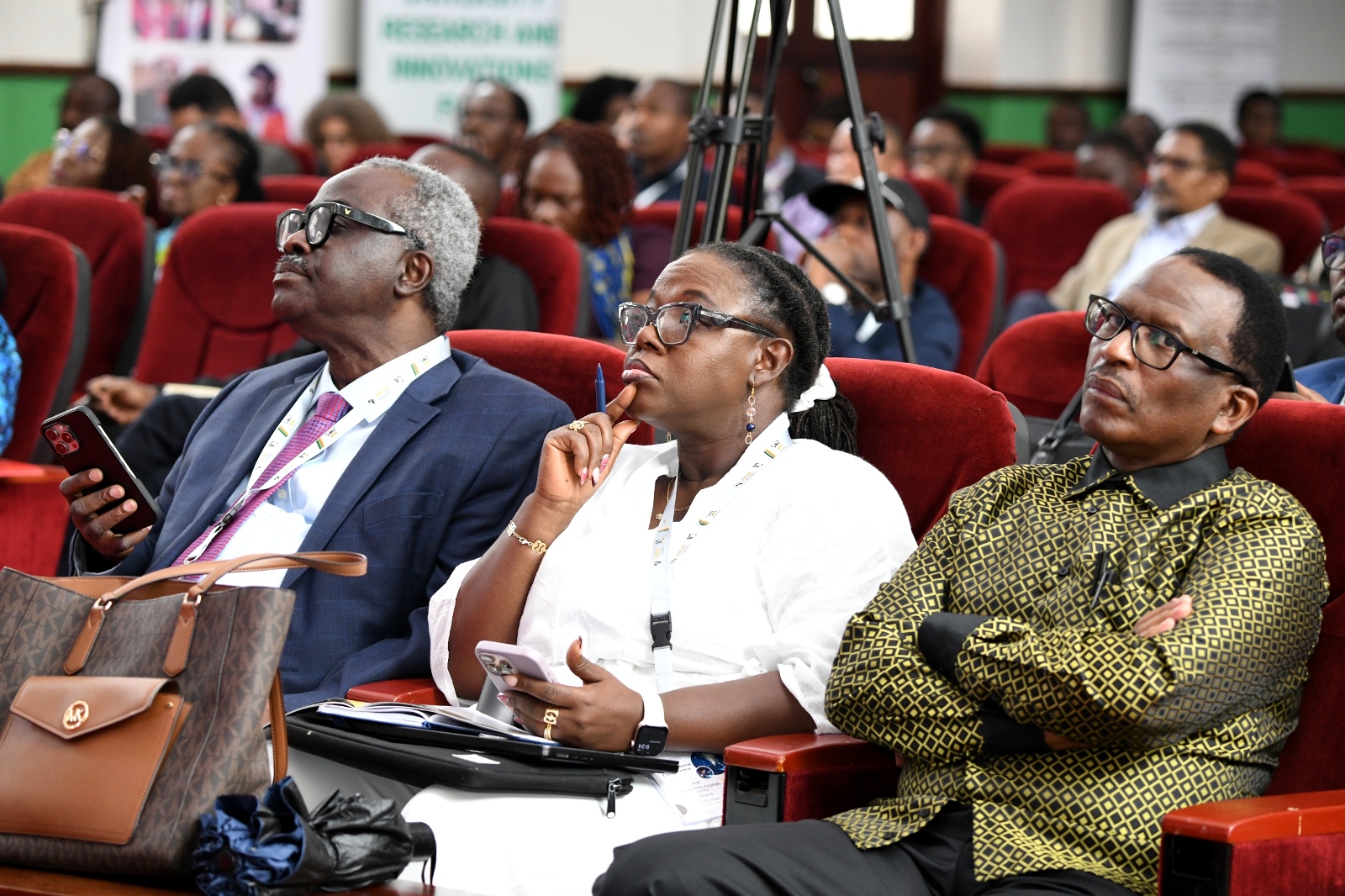 Prof. John Owusu Gyapong (Left), Prof. Sizwe Mabizela (Right) and other delegates follow proceedings. Day 2 of the 5th African Research Universities Alliance (ARUA) Biennial International Conference on Research, Innovation and Artificial Intelligence, October 30, 2025 hosted by Makerere University, Kampala Uganda, East Africa.