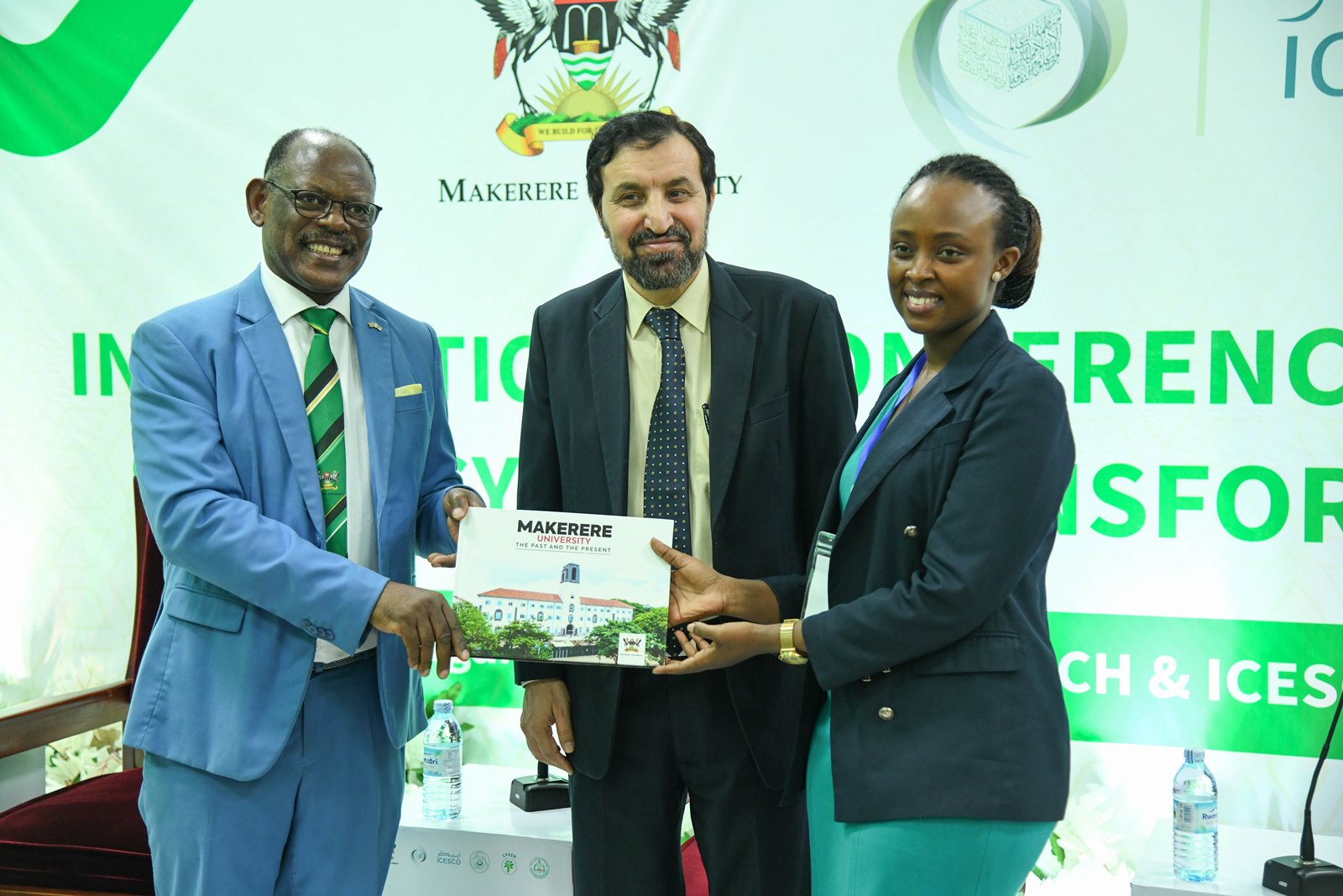 Prof. Barnabas Nawangwe (Left) presents a Makerere Coffee Table book to Ms. Angela Atukunda as H.E. Muhammad Hassan Wazir (Centre) witnesses. Makerere University hosts the International Conference and Training Workshop on Food Systems Transformation for Climate Actions (ICTW-FSTCA 2025) under the COMSTECH Forum for Environment and Ecosystem Restoration (CFEER). Opening Ceremony, 28th October 2025, Main Building, Kampala Uganda, East Africa.