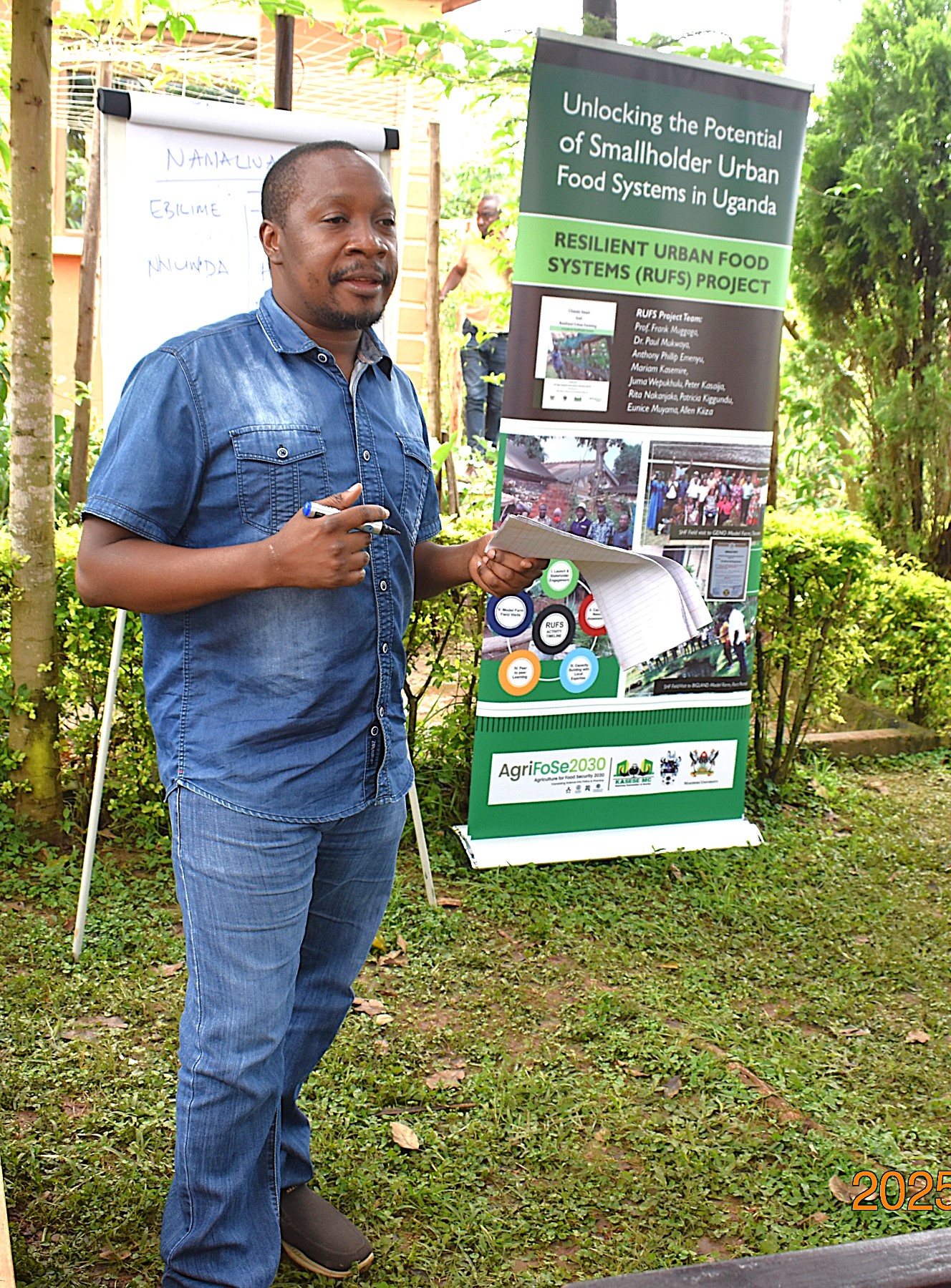 Mr. Peter Kasaija briefs the farmers on the need to document their farming activities to enable the project team to monitor progress. Phase II of the Resilient Urban Food Systems (RUFS) Project, Department of Geography, Geo-Informatics, and Climatic Sciences at Makerere University, Kampala Uganda, East Africa and funded through the AgriFoSe2030 Programme, practical techniques for producing organic fertilizers and pesticides using affordable, locally available materials 6th to 7th October 2025, Emily Royal Mixed Farm, Industrial City Division, Mbale City.
