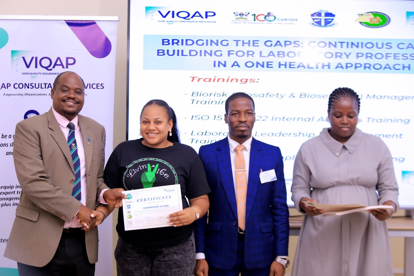 Prof. Lawrence Mugisha- the Chairperson of the National Biosafety Committee awarding Certificate to one of the active participants during the closure of the activity. Centre for Biosecurity and Global Health (CeBIGH) and the Department of Biosecurity, Ecosystems and Veterinary Public Health (BEP) in collaboration with VIQAP Consultancy Services, the Uganda Medical Laboratory Technologists Association (UMLTA), the Biosafety and Biosecurity Association of Uganda (BBAU), and the Uganda National Health Laboratories and Diagnostic Services, conducted a three-day Biorisk Management (Biosafety and Biosecurity) training, 20th to 22nd October 2025 at COVAB, Makerere University, Kampala Uganda, East Africa.