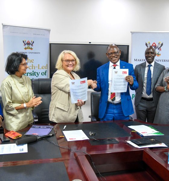Prof. Barnabas Nawangwe (3rd R) and Ms. Jo Midgley (3rd L) shake hands after signing the MoU as H.E. Nimisha Madhvani (2nd L), H.E. Miriam Otengo (L), Prof. Helen Nambalariwa Nkabala (R) and Mr. Emmanuel Kitamirike (2nd R) witness on 17th October 2025. Makerere University and the University of the West of England (UWE) sign MoU aimed at strengthening collaboration in research, innovation, and enterprise development, 17th October 2025, Main Building, Kampala Uganda, East Africa.