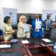 Prof. Barnabas Nawangwe (3rd R) and Ms. Jo Midgley (3rd L) shake hands after signing the MoU as H.E. Nimisha Madhvani (2nd L), H.E. Miriam Otengo (L), Prof. Helen Nambalariwa Nkabala (R) and Mr. Emmanuel Kitamirike (2nd R) witness on 17th October 2025. Makerere University and the University of the West of England (UWE) sign MoU aimed at strengthening collaboration in research, innovation, and enterprise development, 17th October 2025, Main Building, Kampala Uganda, East Africa.