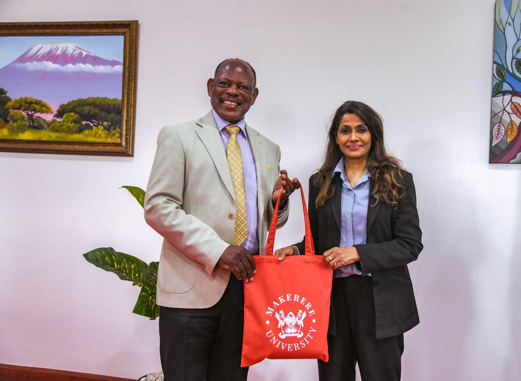 Puan Sri Datin, Prof. Dr. Rohini Devi receives a souvenir from the Vice Chancellor, Prof. Barnabas Nawangwe. Makerere University has started preliminary discussions with Binary University of Management and Entrepreneurship (Malaysia) to deepen its global partnerships through high-level engagements, aimed at fostering innovation-driven education, entrepreneurship, and women’s leadership, Main Building, 21st November 2025, Kampala Uganda, East Africa.